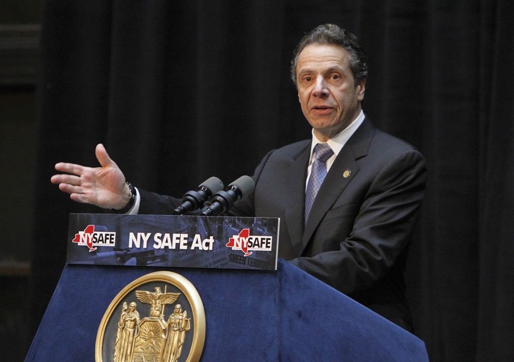 NY Gov. Andrew Cuomo addresses the audience during the NY Safe Act signing ceremony at City Hall in Rochester Wednesday, Jan. 16, 2013.  Cuomo signed into law on Tuesday  legislation  that tightens a ban on assault-style rifles, calls for background checks on ammunition purchases, outlaws large-capacity magazines and tries to keep guns out of the hands of mentally ill people deemed to be a threat.  (AP Photo/Democrat & Chronicle, Shawn Dowd)  MAGS OUT; NO SALES